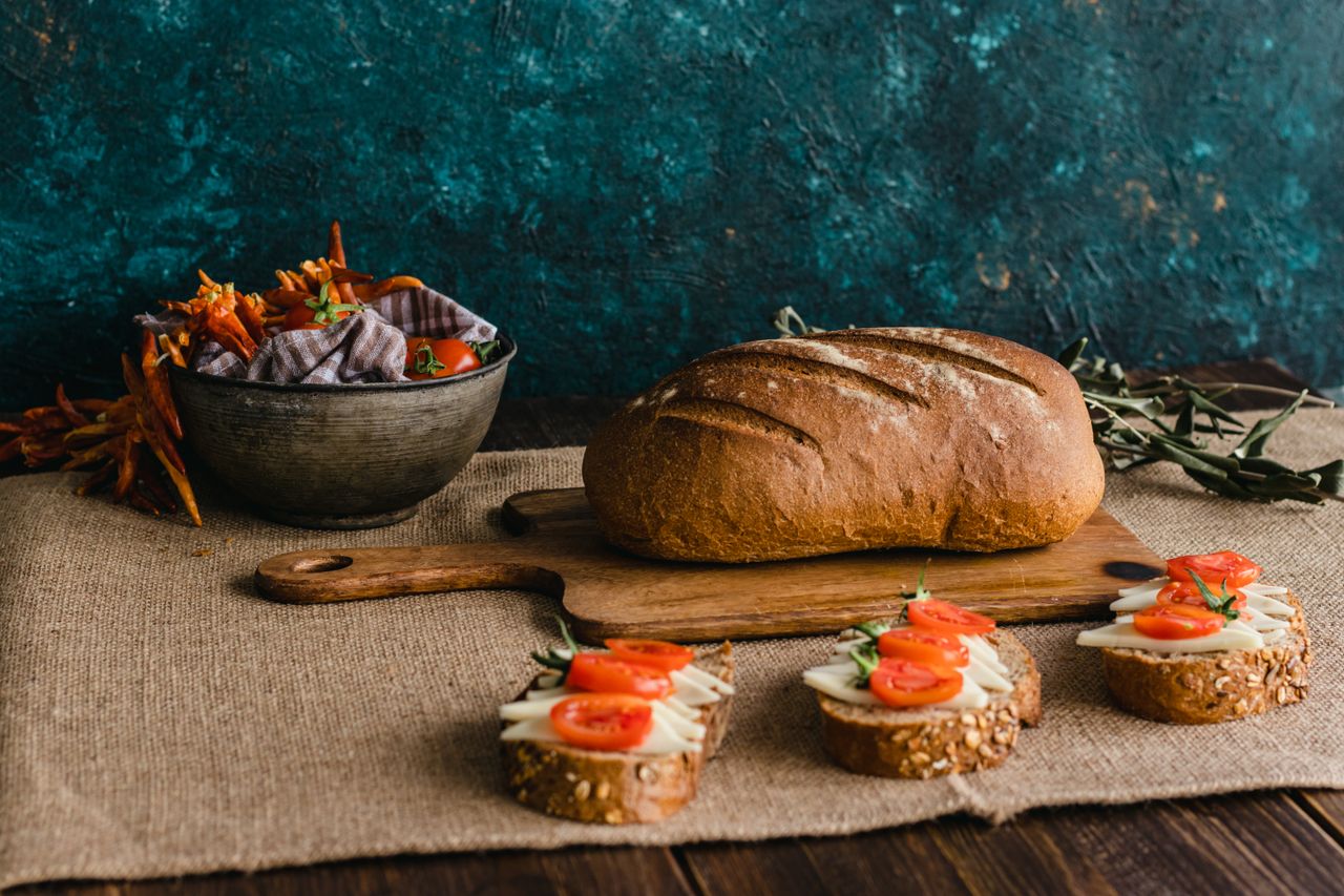 A rustic still life featuring bread, cheese, and tomatoes in Istanbul's classic setting.