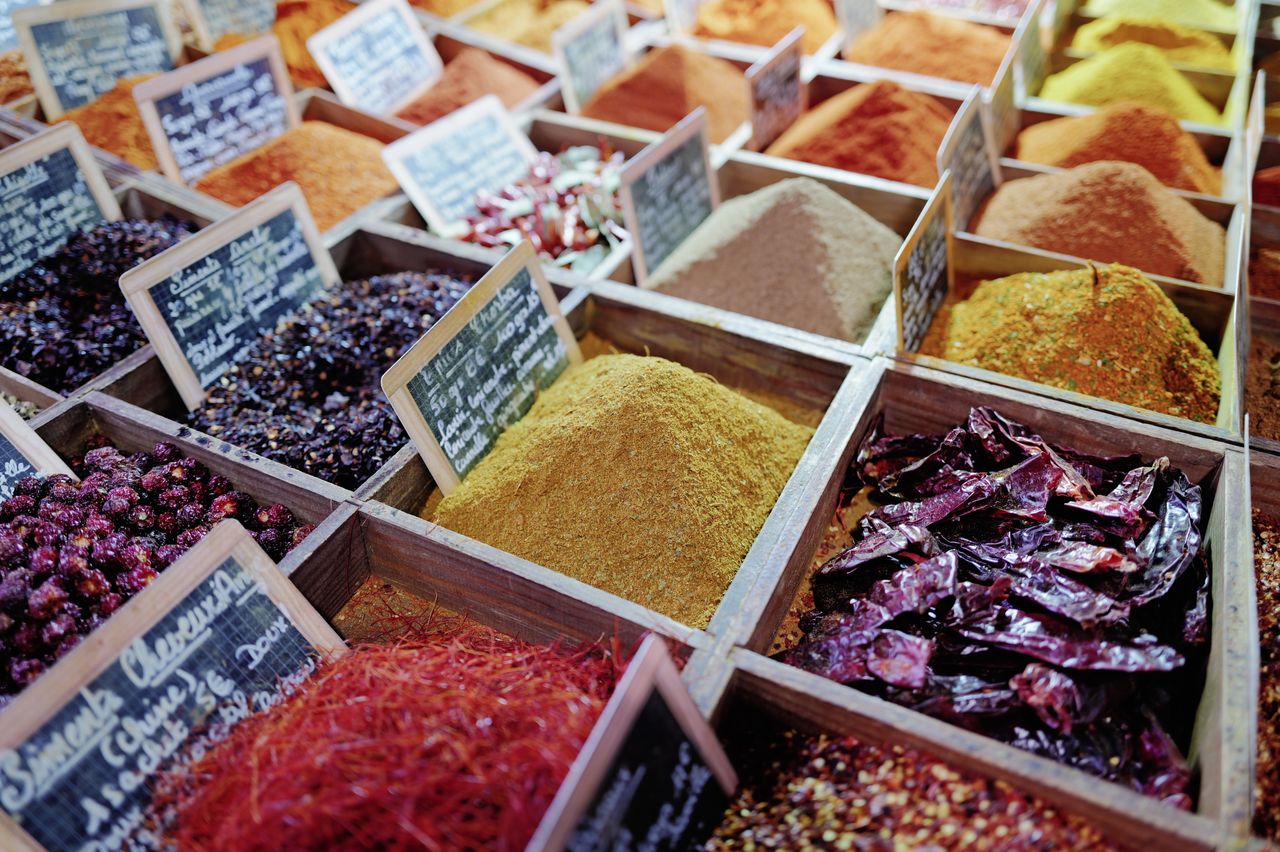 Vibrant selection of spices and herbs on display at a local market stall.